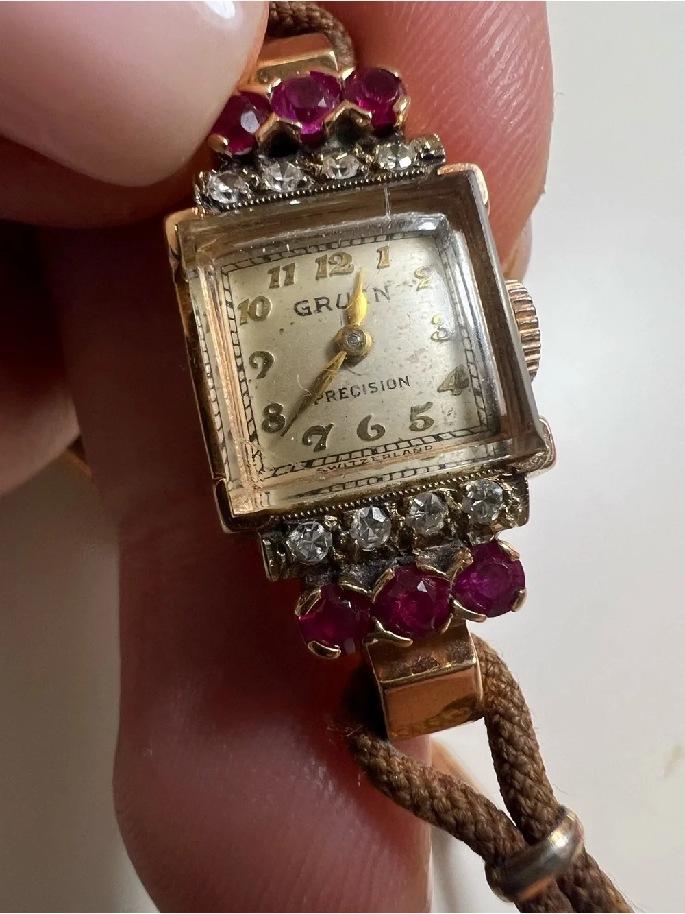 Gruen Precision wristwatch crafted in 14k rose gold with rubies and diamonds
